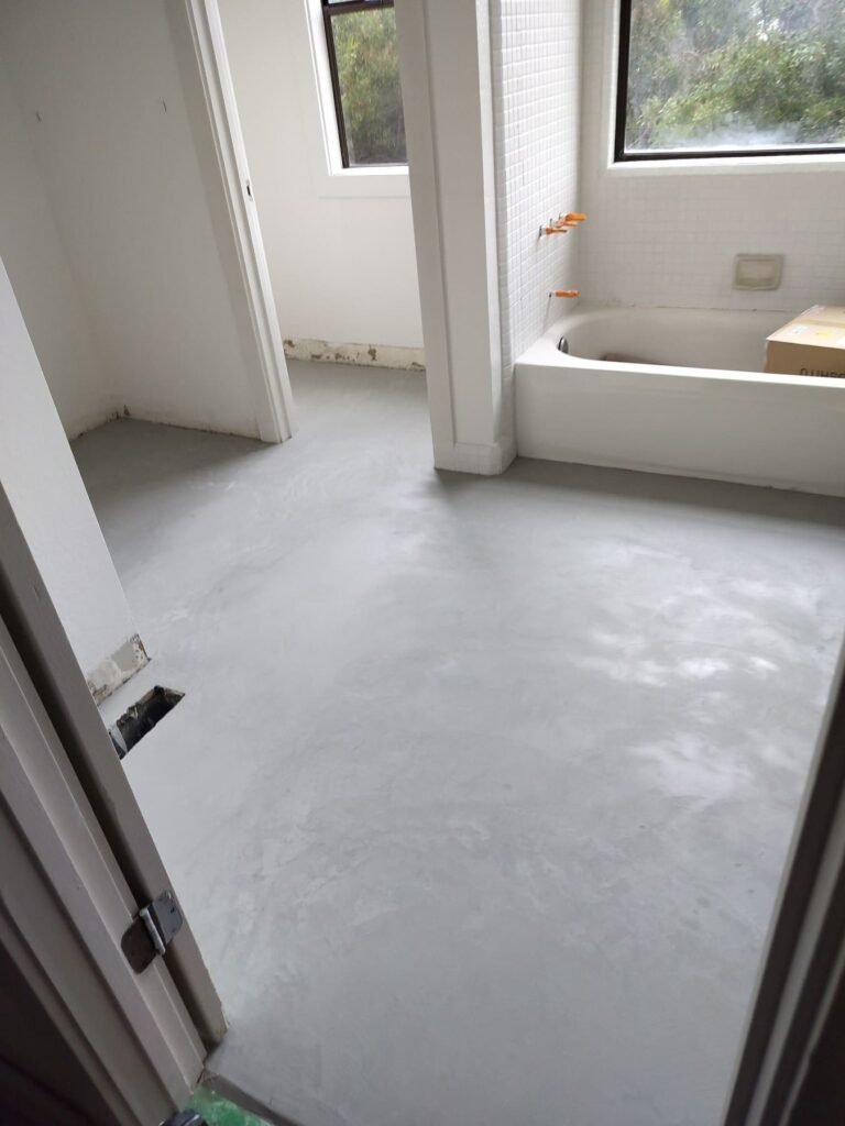 After: seamless microcement floor with no grout joints