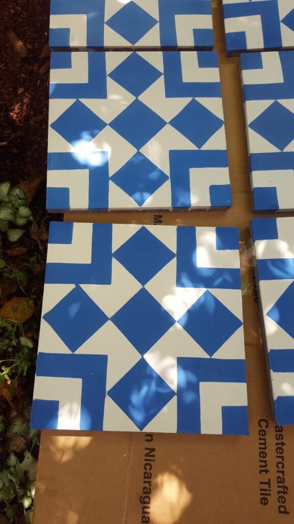 Close-up of blue-and-white geometric tiles laid out before installation for the Mill Valley bathroom project.